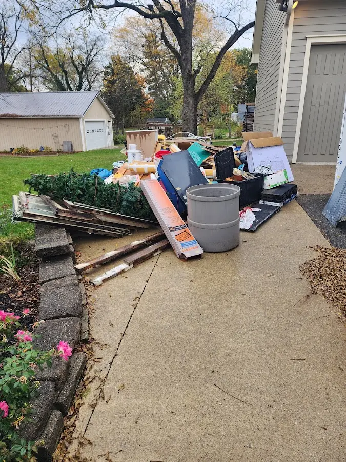 Dumpster being loaded with debris for 10 Yard Dumpster Rental in Warren
